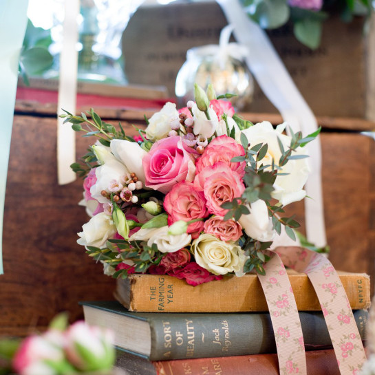 Vintage flowers and books as a wedding display.