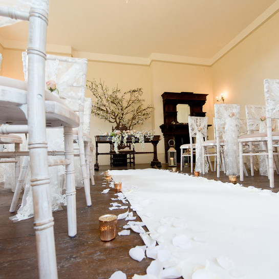 Decorating the aisle for a Civil Ceremony in the Edwardian Room.