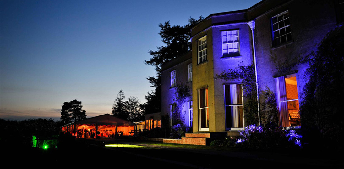 Led lighting on the house and marquee at twilight. We can programme the colours to go with your wedding colour scheme.